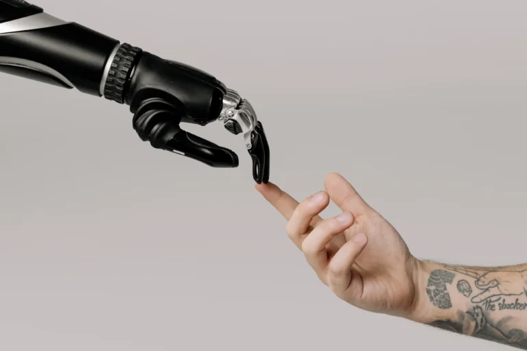 Robot hand touching a human hand.