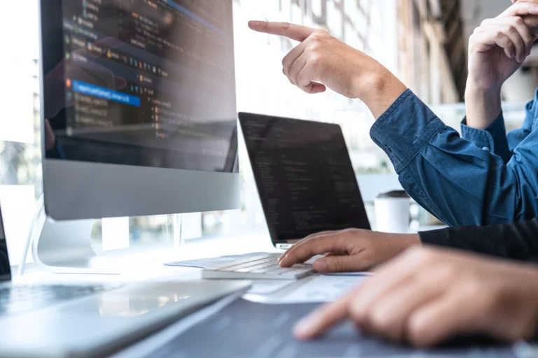 Man's hand pointing at screen identifying target keywords.